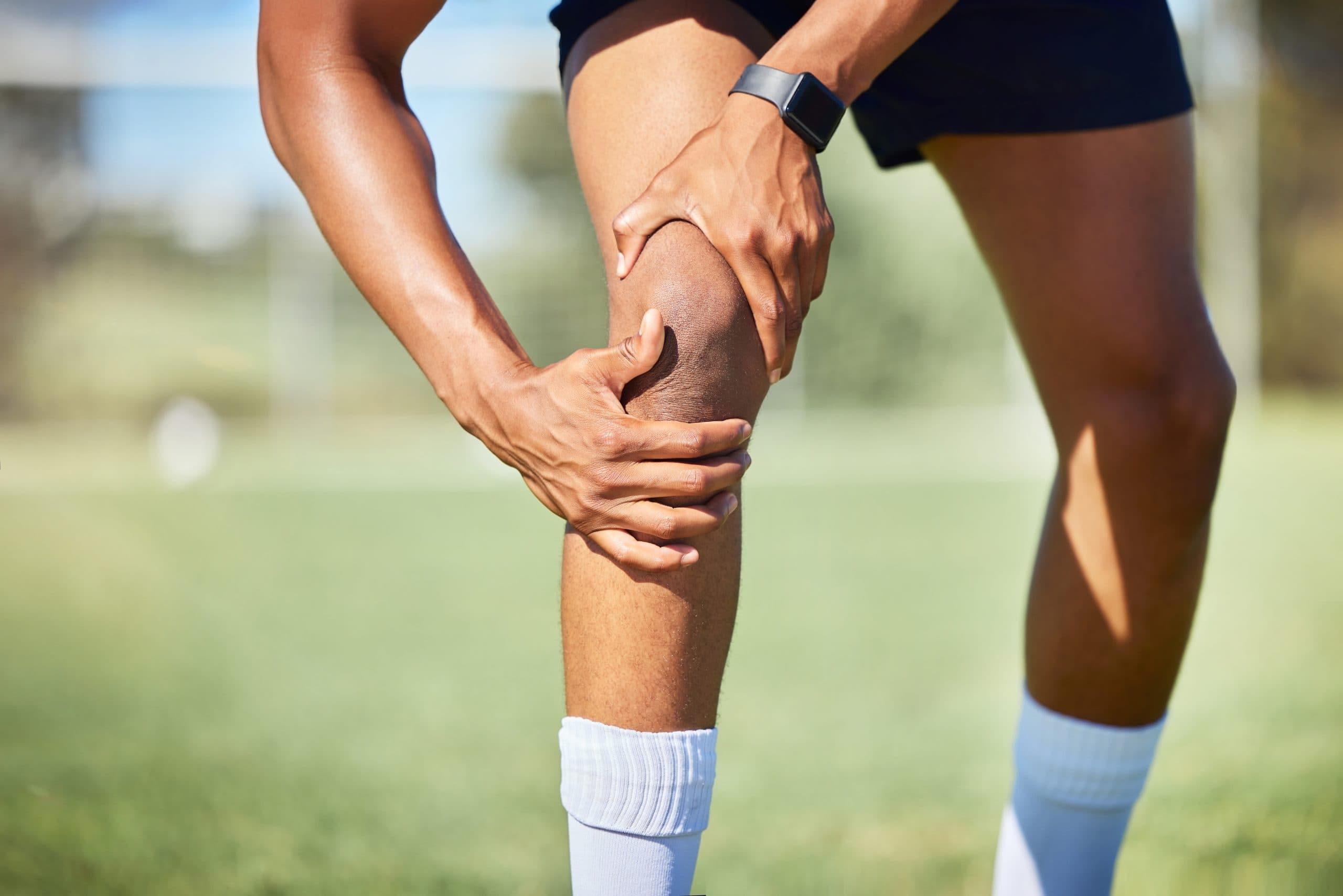 Athlete with knee pain outdoors