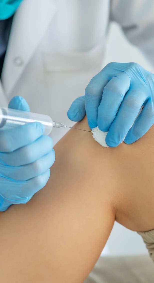 Clinician delivering a prepared joint injection
